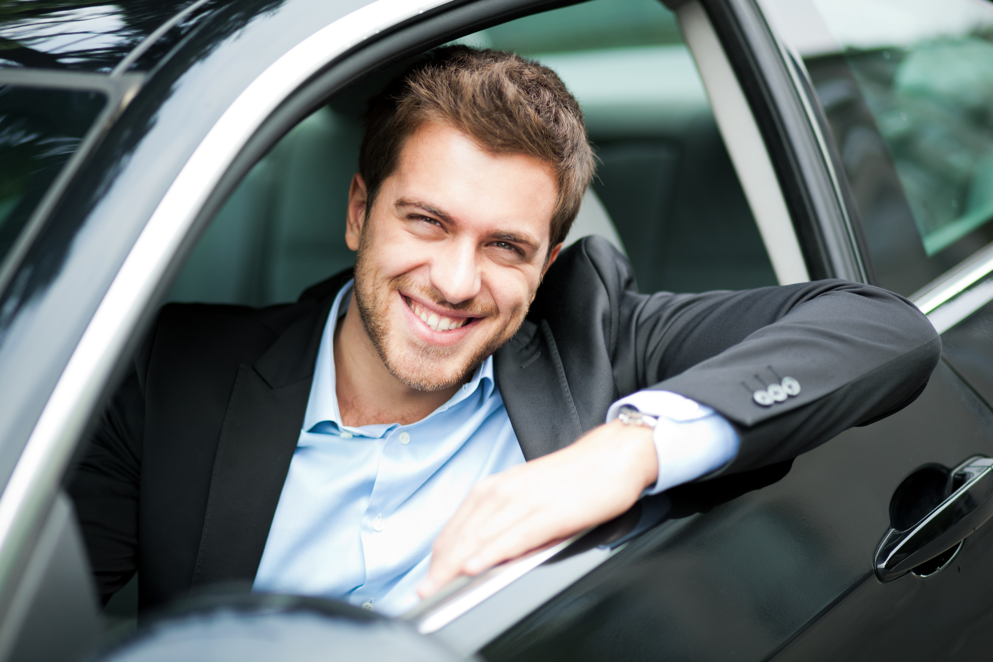 Young Man Sitting In A Car